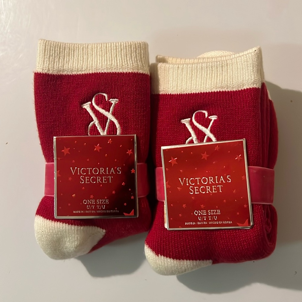 2 pairs of red and white Victoria’s Secret holiday socks.